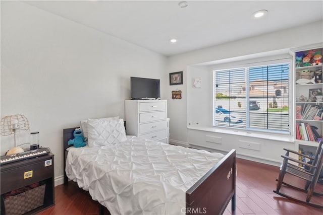 bedroom with dark wood-type flooring