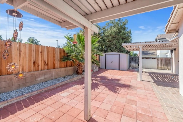 view of patio / terrace with a pergola and a shed