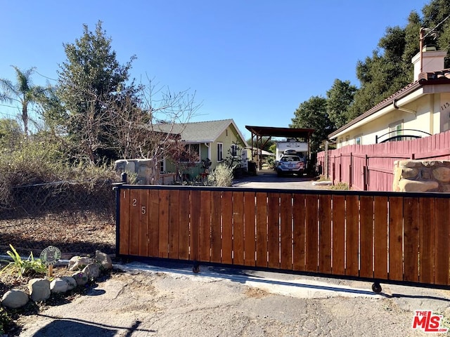 view of gate featuring a carport