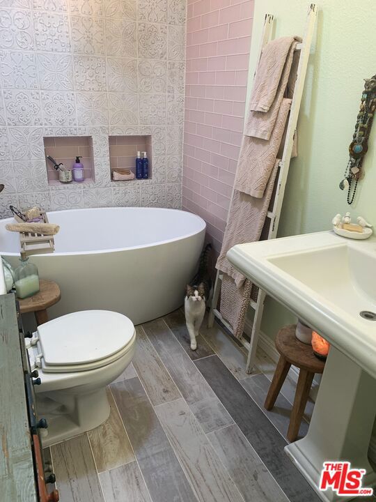 bathroom with a tub and toilet