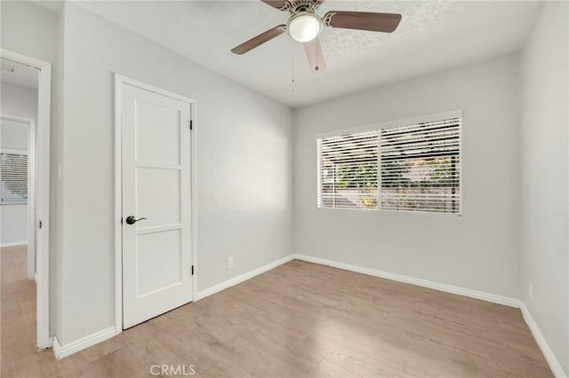 spare room featuring ceiling fan, a textured ceiling, and light wood-type flooring