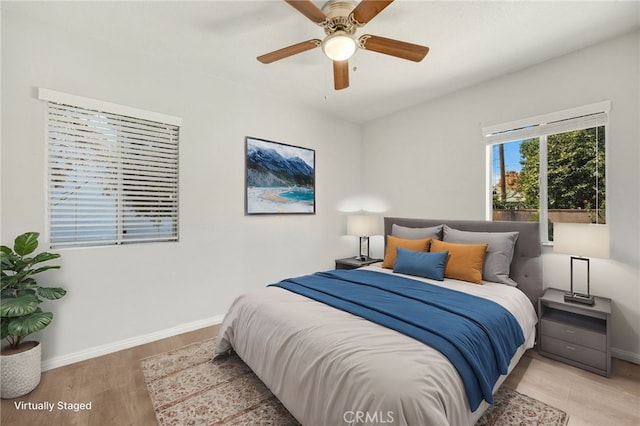 bedroom with ceiling fan and light hardwood / wood-style floors