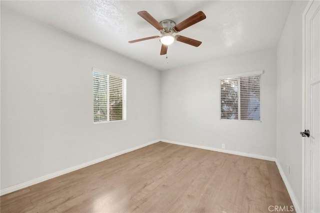 unfurnished room with hardwood / wood-style flooring and ceiling fan