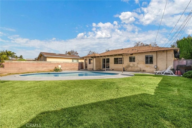 view of pool with a yard