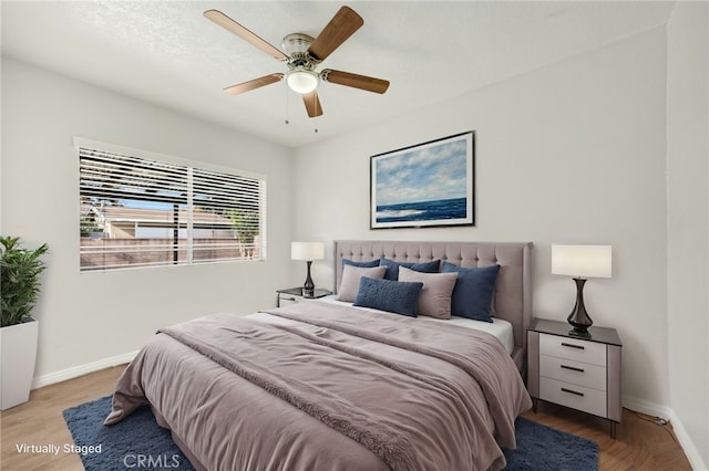 bedroom featuring ceiling fan and light hardwood / wood-style flooring