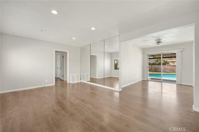 unfurnished room with hardwood / wood-style flooring and ceiling fan