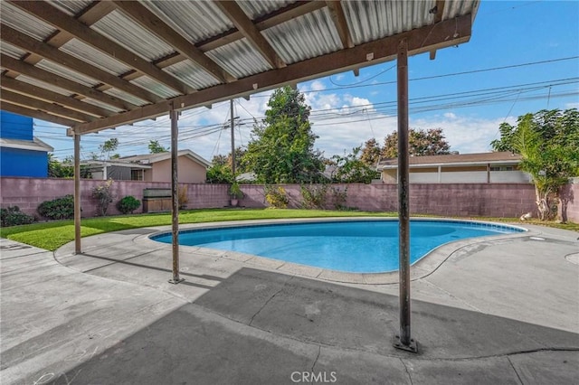 view of pool featuring a yard and a patio