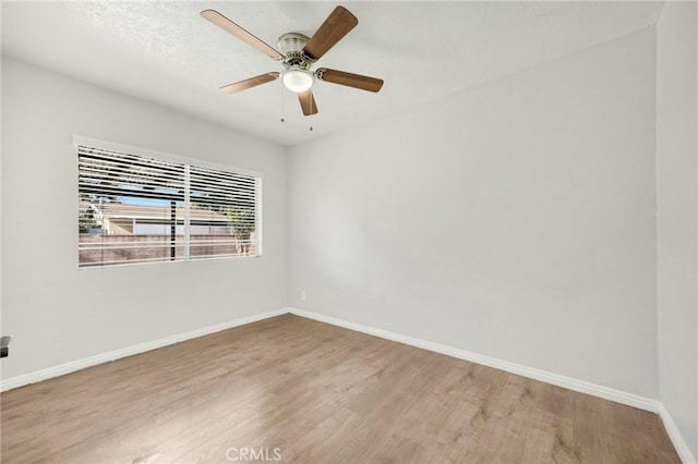 unfurnished room featuring ceiling fan and wood-type flooring