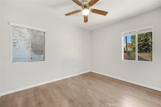 unfurnished room with hardwood / wood-style floors and ceiling fan