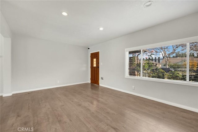 empty room with hardwood / wood-style flooring