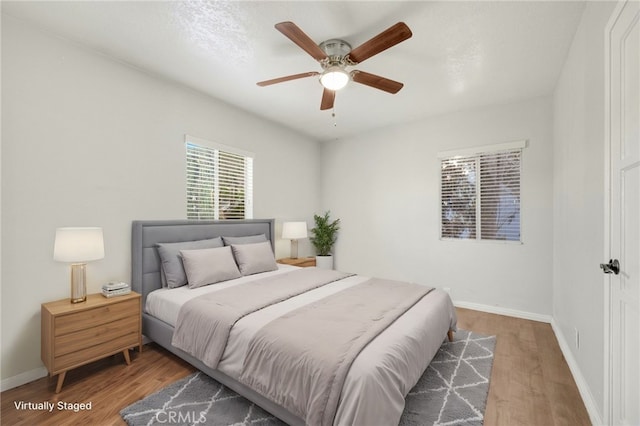 bedroom with wood-type flooring and ceiling fan