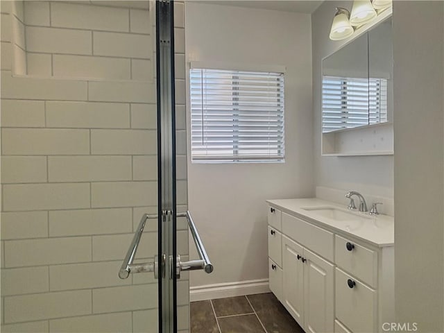 bathroom with vanity and a shower with shower door