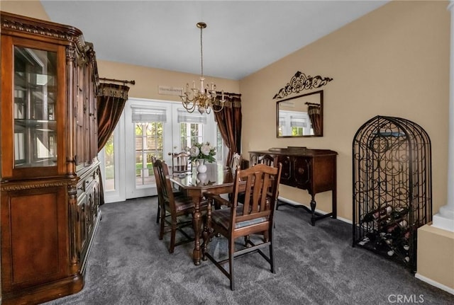 carpeted dining space featuring a chandelier and french doors