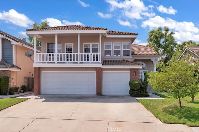 mediterranean / spanish house featuring a front lawn and a garage