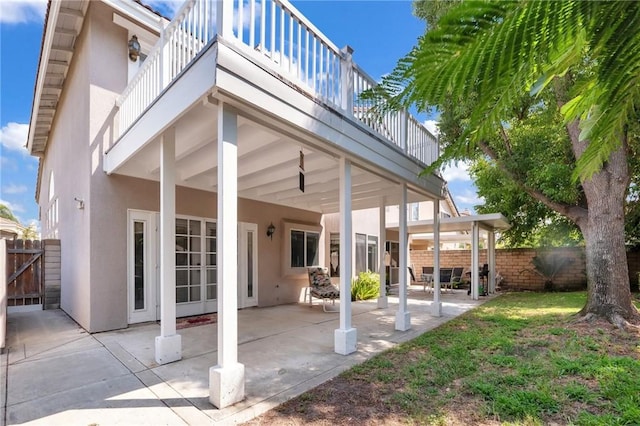 rear view of house with a patio area and a balcony