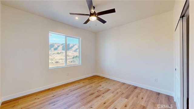 empty room featuring ceiling fan and light hardwood / wood-style floors