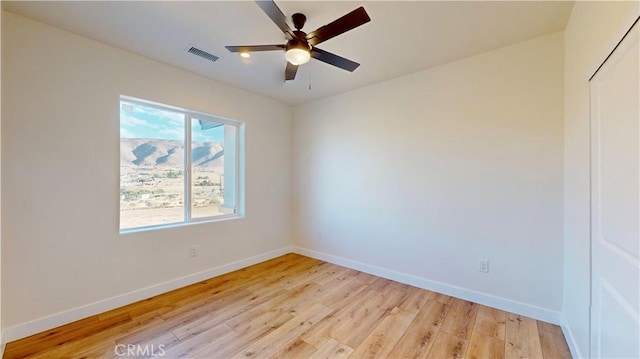 spare room featuring ceiling fan and light hardwood / wood-style flooring