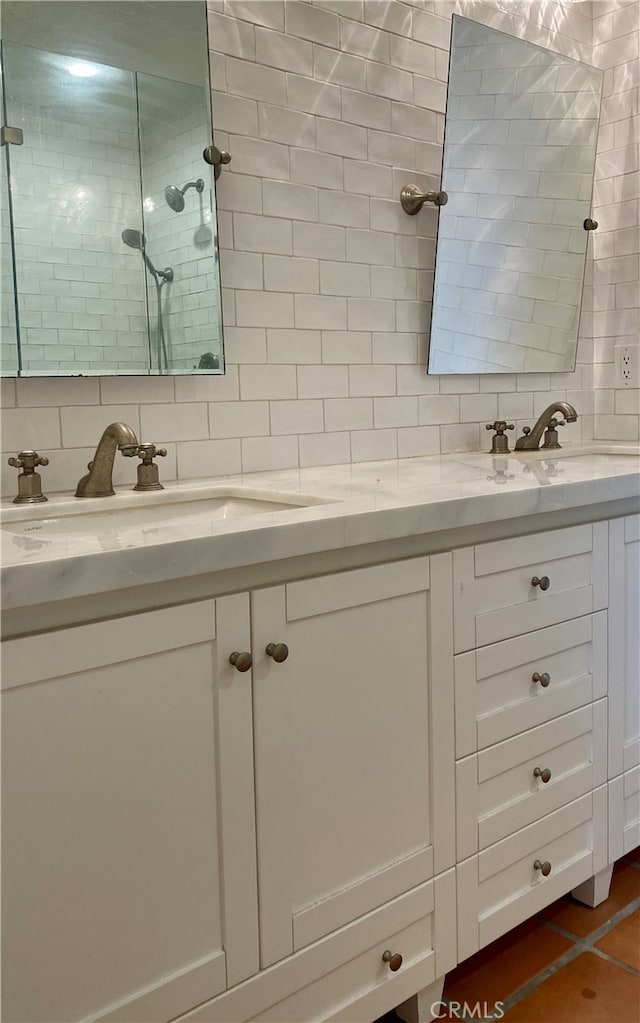 bathroom with vanity, tiled shower, backsplash, and tile patterned floors