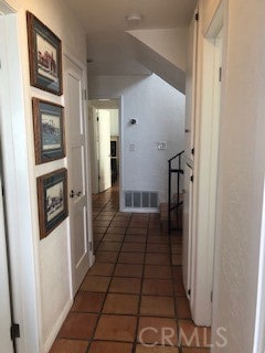 corridor featuring dark tile patterned floors