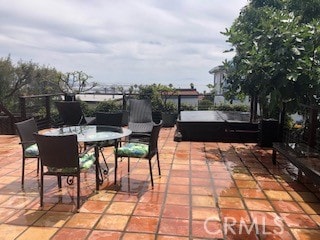 view of patio / terrace with a hot tub