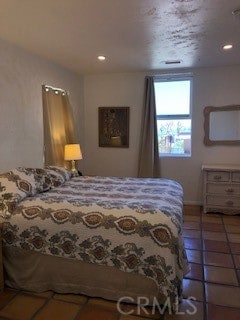 bedroom with dark tile patterned floors