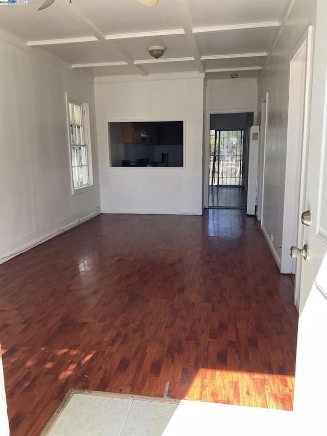 unfurnished living room with coffered ceiling, ceiling fan, and dark wood-type flooring