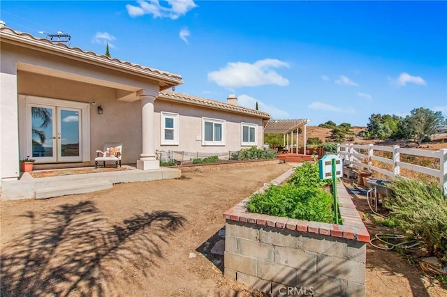 back of house with french doors and a pergola