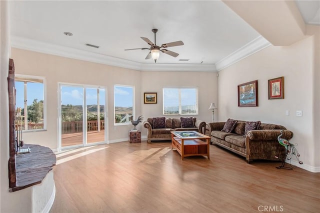 living room featuring ceiling fan, light wood-type flooring, and crown molding