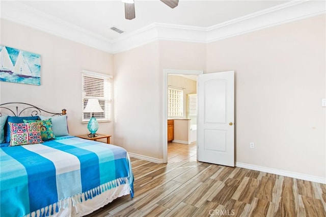 bedroom featuring hardwood / wood-style floors, ceiling fan, and crown molding