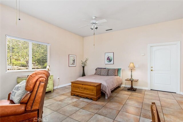 tiled bedroom with ceiling fan