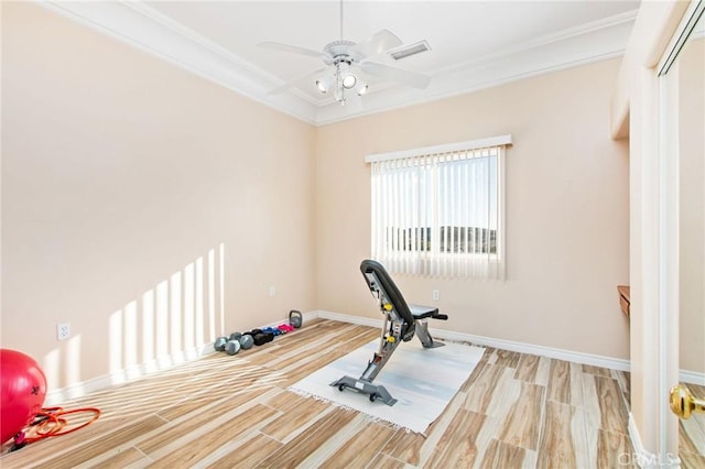 exercise room with light hardwood / wood-style floors, ceiling fan, and crown molding