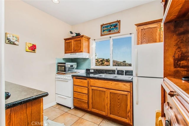 kitchen featuring backsplash, sink, light tile patterned flooring, and white appliances