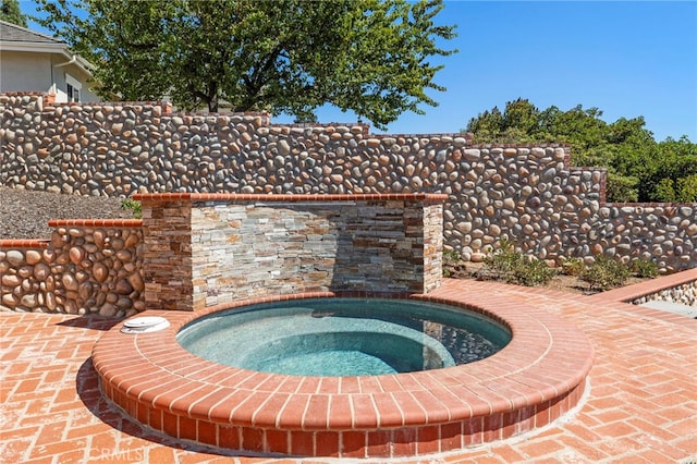 view of pool with an in ground hot tub