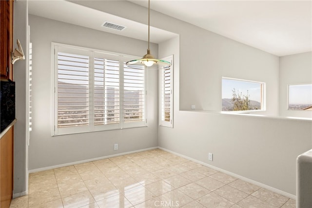 unfurnished dining area with plenty of natural light and light tile patterned floors