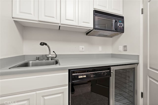 kitchen featuring sink, black appliances, white cabinets, tile patterned flooring, and wine cooler