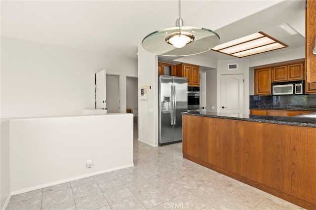 kitchen with pendant lighting, dark stone counters, decorative backsplash, kitchen peninsula, and stainless steel appliances