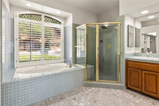 bathroom with separate shower and tub and vanity