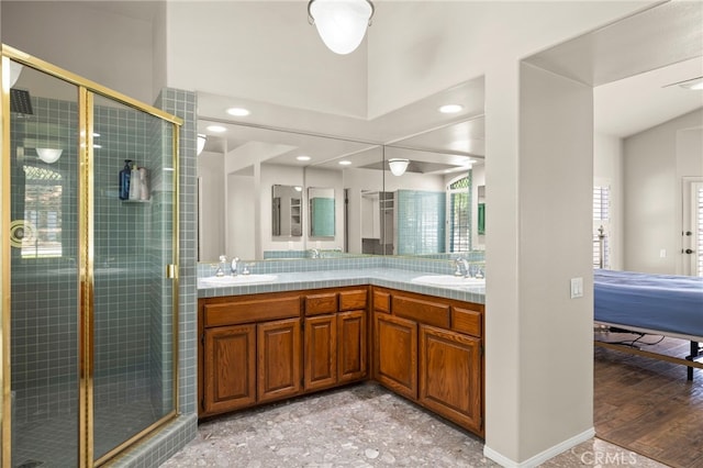 bathroom with hardwood / wood-style flooring, vanity, and an enclosed shower