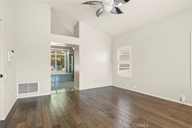 empty room with ceiling fan, dark hardwood / wood-style flooring, and high vaulted ceiling