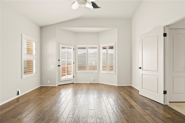 spare room featuring dark hardwood / wood-style floors, ceiling fan, and vaulted ceiling