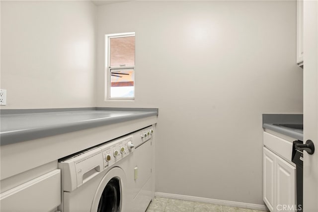 laundry room featuring washing machine and clothes dryer, light tile patterned floors, and cabinets