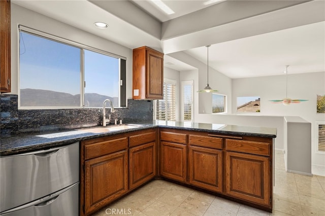 kitchen with a mountain view, dishwasher, backsplash, ceiling fan, and kitchen peninsula