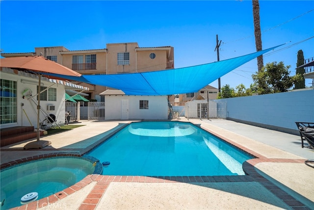 view of pool featuring a patio and an in ground hot tub