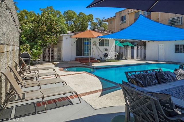 view of swimming pool featuring a patio area