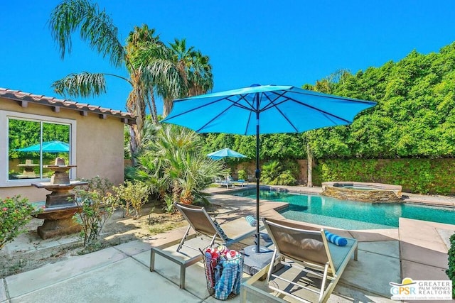 view of patio with a swimming pool with hot tub