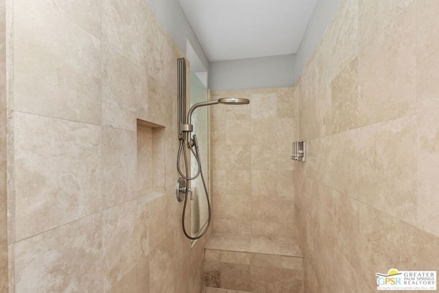 interior details featuring a tile shower