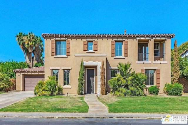 mediterranean / spanish-style home featuring a balcony, a front yard, and a garage