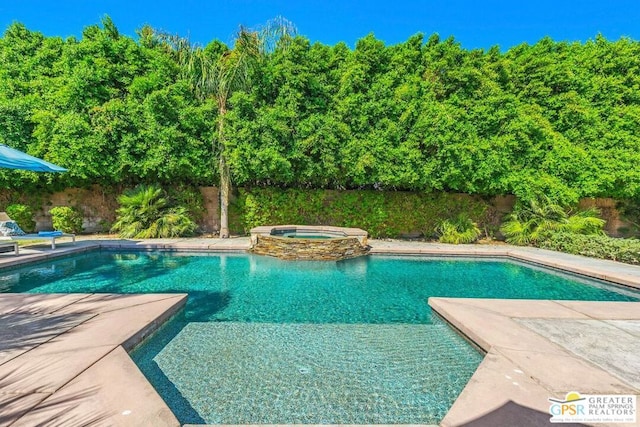 view of pool featuring a patio and an in ground hot tub