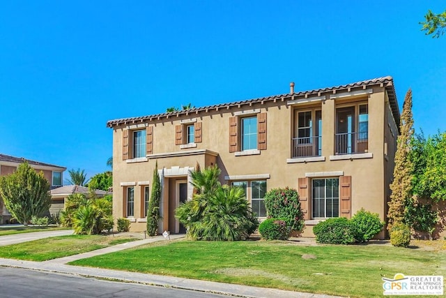 mediterranean / spanish home featuring a front yard