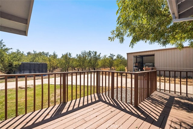 wooden terrace featuring a yard